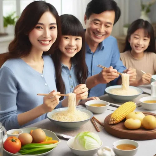 A happy family sitting around a dining table enjoying a meal.